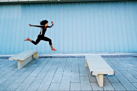 woman leaping benches