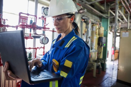 woman works laptop power plant