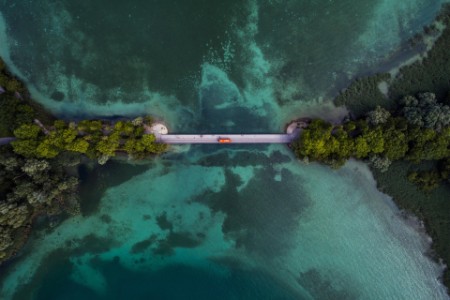 Drone shot looking down on a bridge crossing over lake Konstanz, Bavaria, Germany