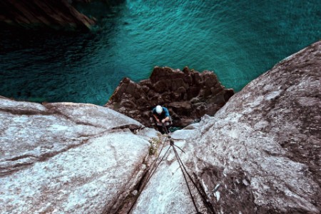 Photographic portrait of man rock climbing