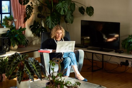 Mature woman using laptop in living room