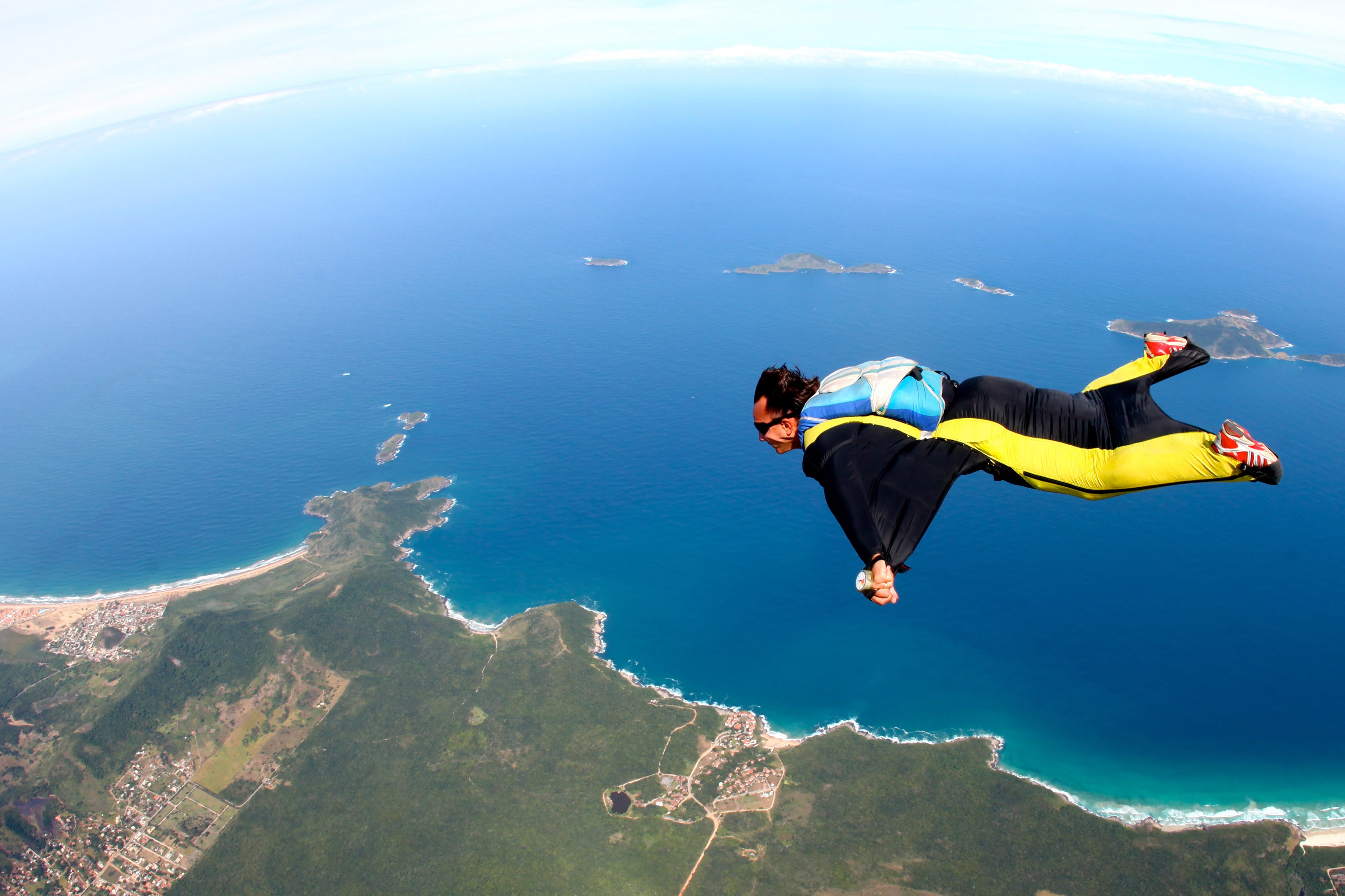 Skydive flying wing suit over beach image