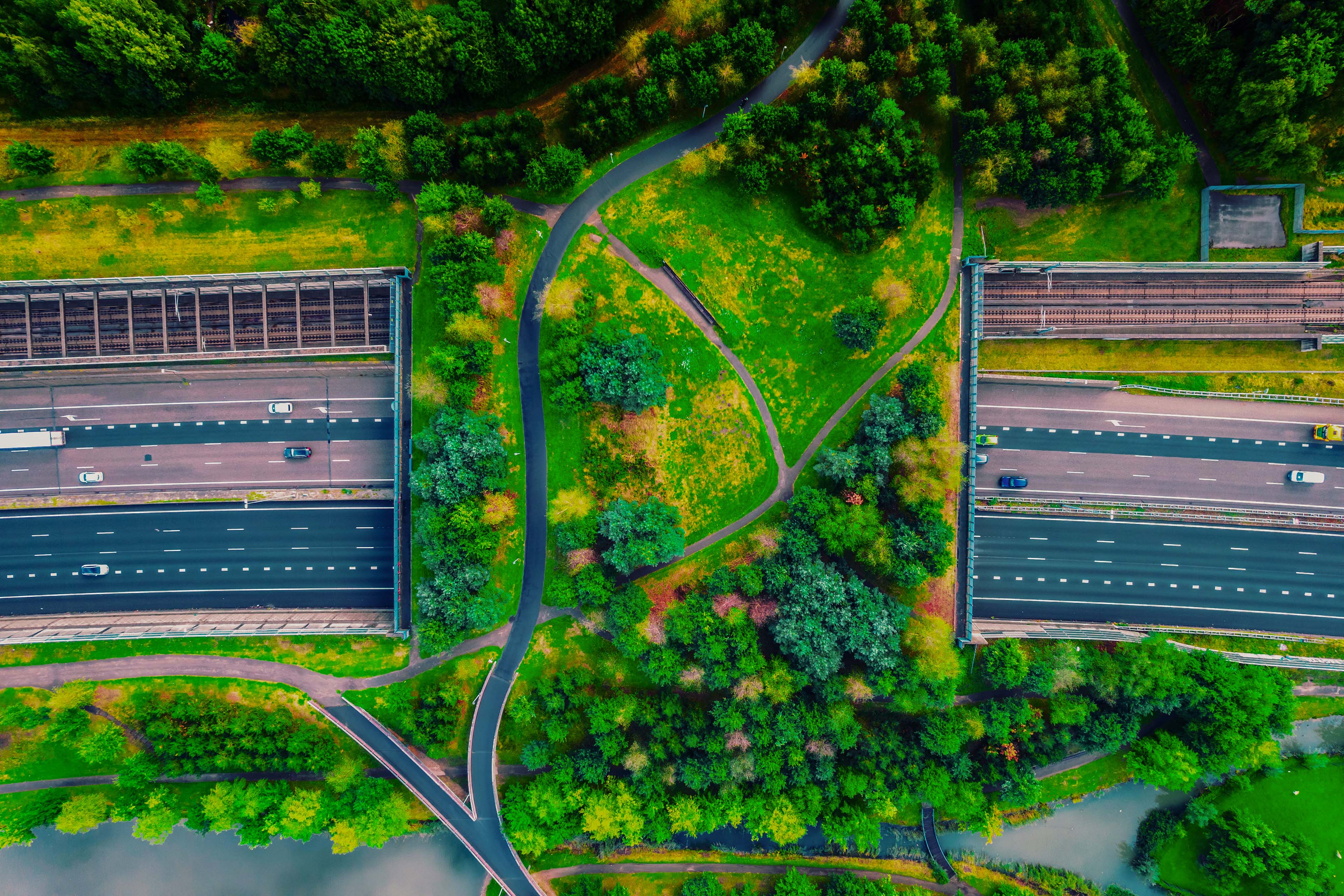 Drone view of green bridge with public park crossing above highway netherlands