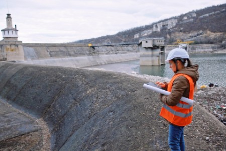 Female engineer working in hydroelectric dam