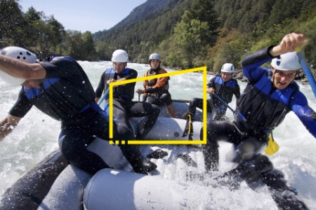 Group of men whitewater rafting