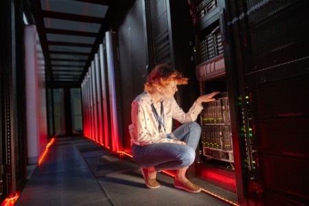 IT technician examining panel server room