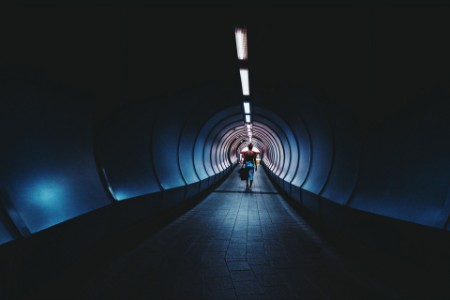 woman walking through tunnel