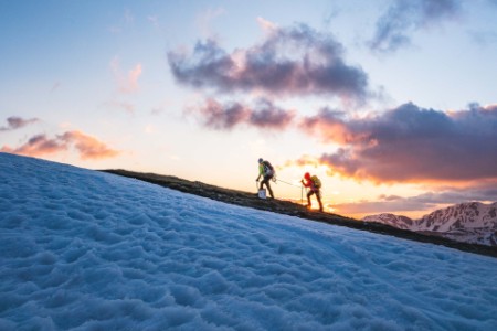 Hikers explore snow-capped mountain landscape
