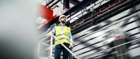 Industrial man engineer standing in a factory