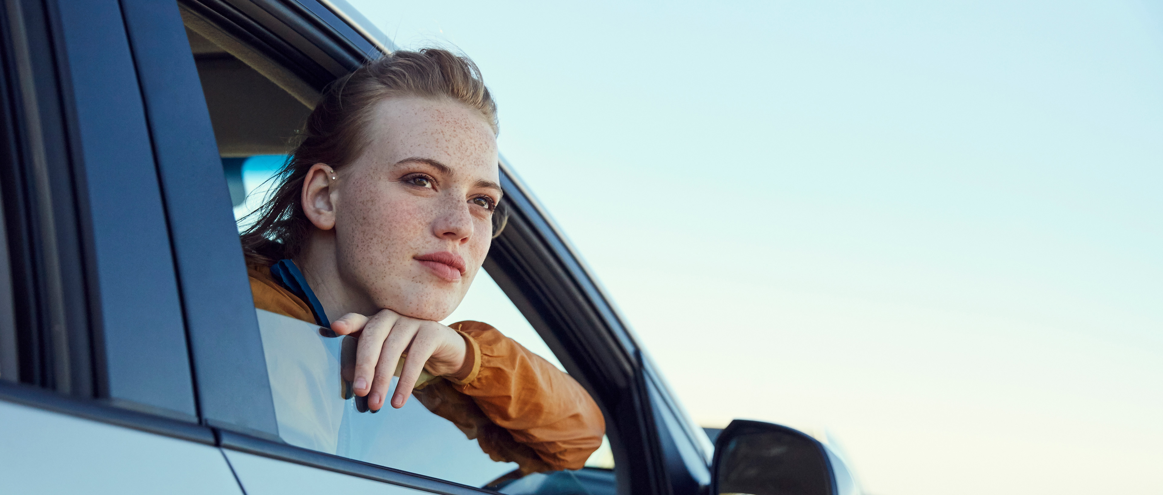 Young woman looking out of a car