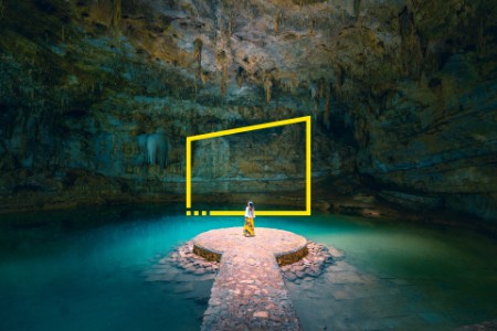 Woman standing alone in a cenote in Mexico