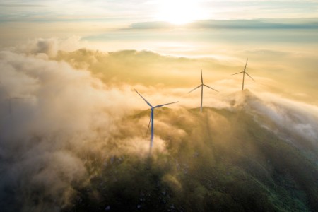 Aerial view of wind farm on the coast on a misty morning