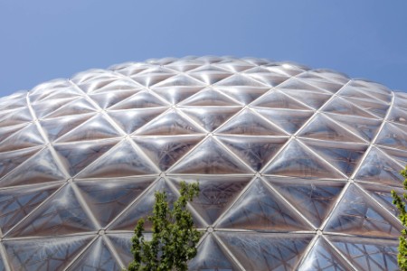 biodome with blue sky and green trees