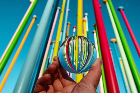Close-up of hand holding multi-colored straws