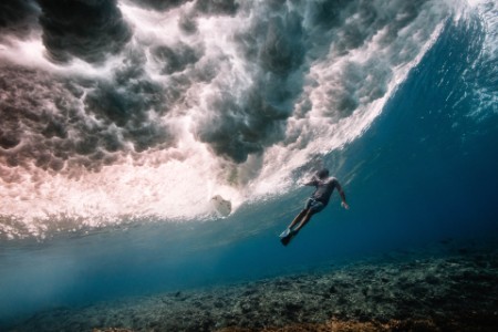 Free diver beneath breaking waves