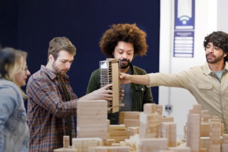Professor handing a polished building model to the student