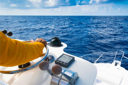 boat captain steering yellow jacket