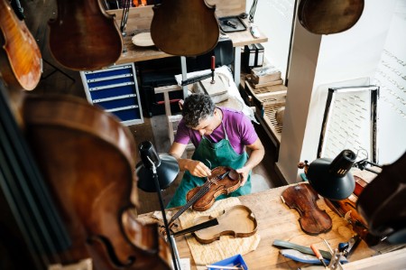 violin maker working instrument