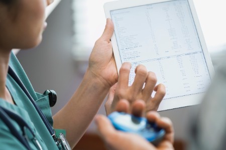 nurse showing patient digital tablet