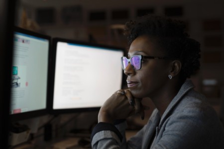 Focused businesswoman working late computers office