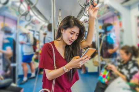 Woman checking her phone in train