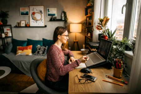 Young woman working from home office.