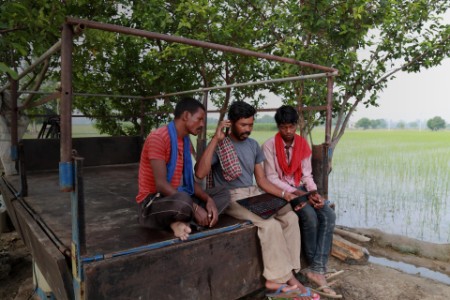 Rural people using laptop outdoor in the nature