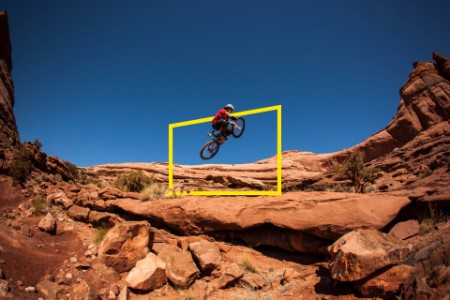 A man getting air on a jump on his montain bike near Moab, Utah.