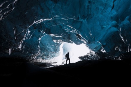 Explorer walking inside the cave