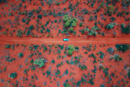 Car driving on the red centre roads in the australian outback