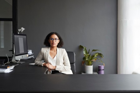 Confident businesswoman sitting at office desk