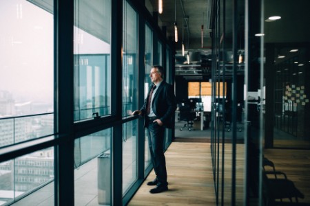Senior businessman in suit looking out of window