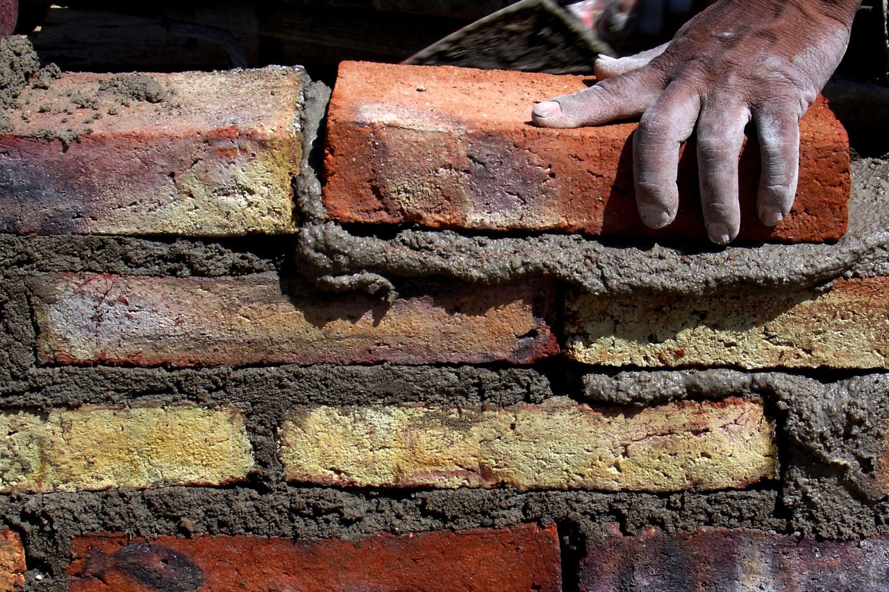 Hand laying bricks image