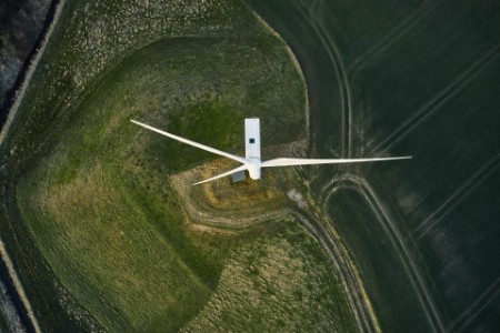 Drone view directly above wind turbine in field