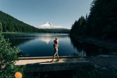 A father carries his daughter on his shoulders at Trillium Lake