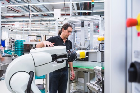 man assembly robot factory