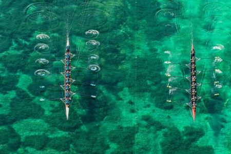 Aerial view of two 8-seat row crews competing