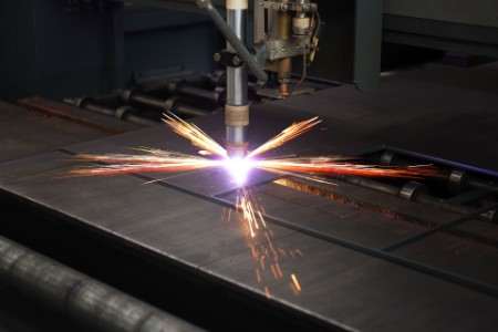 Industrial CNC plasma machine cutting of metal plate