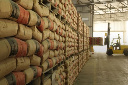 ey warehouse full of sacks stacked from floor to ceiling