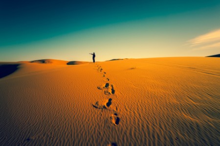 Woman and footprints in the desert