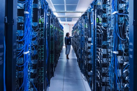 Woman standing in the aisle of server room