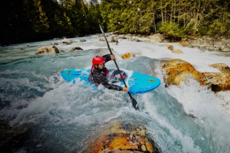 Kayaker entering white water rapids
