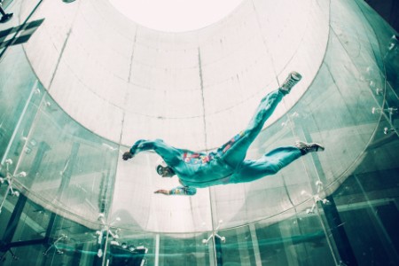 mann simulerer innendørs fallskjermhopping