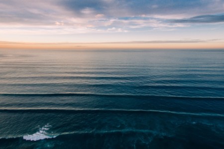 The ocean as sunset as seen from a drone