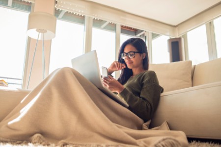 A women working from home under a blanket