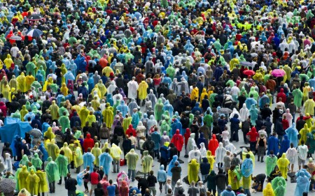 Large crowd of festival go-ers wearing the same raincoats