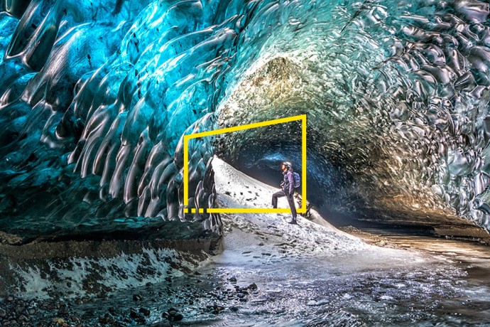 Man standing in frozen cave