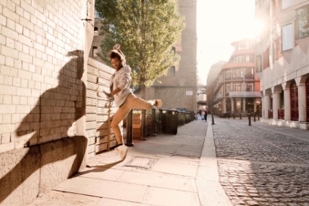 street dancer creating striking shadow on wall