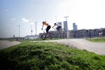 two young women mid air on bmx bikes