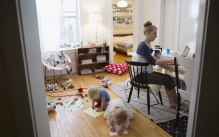  Woman working from home with children